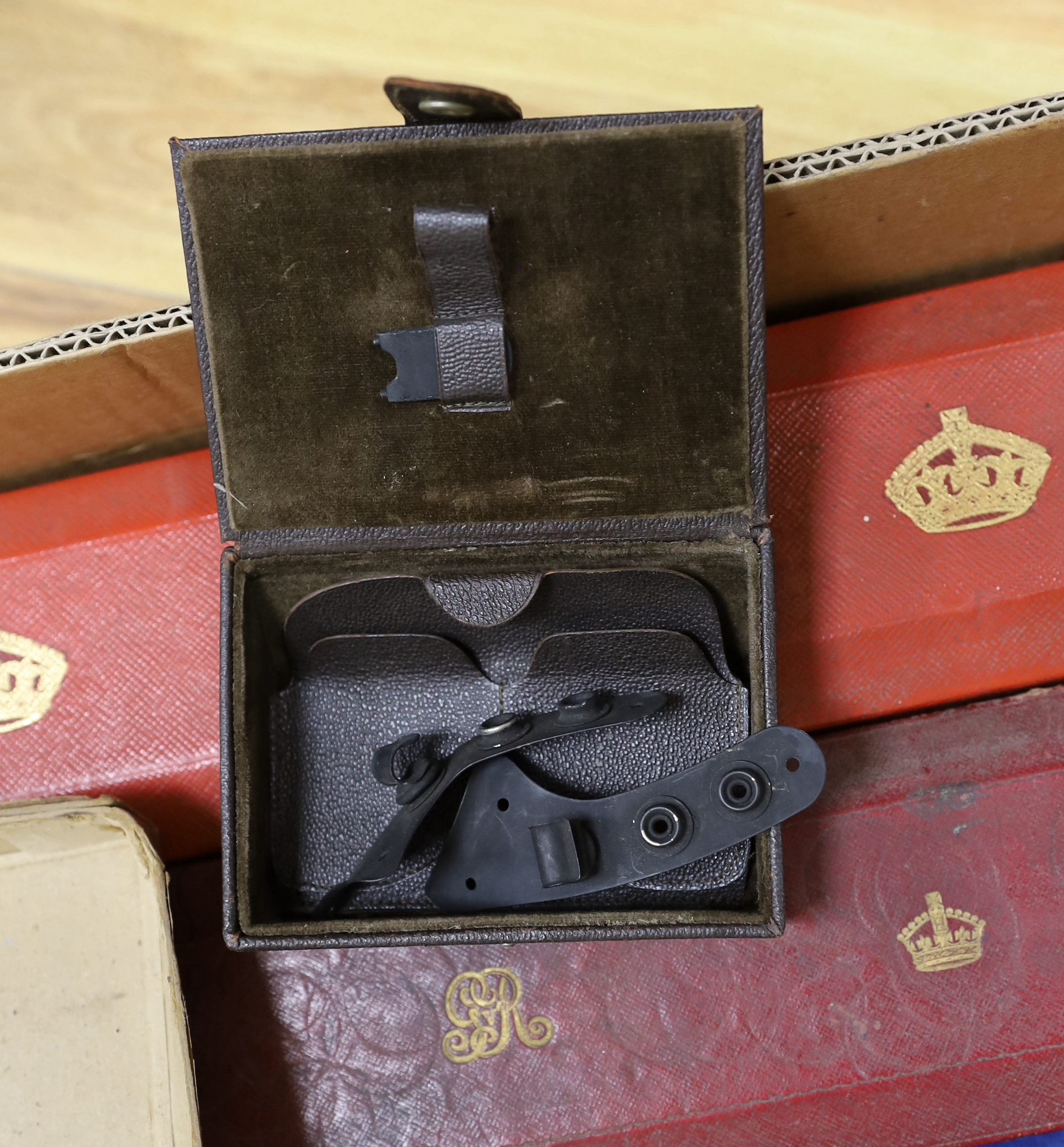 A collection of militaria, including; a pair of First World War military leather boots with wooden boot stretchers, two scroll boxes with Royal Cyphers for George V and Elizabeth II, a four draw telescope, a large union